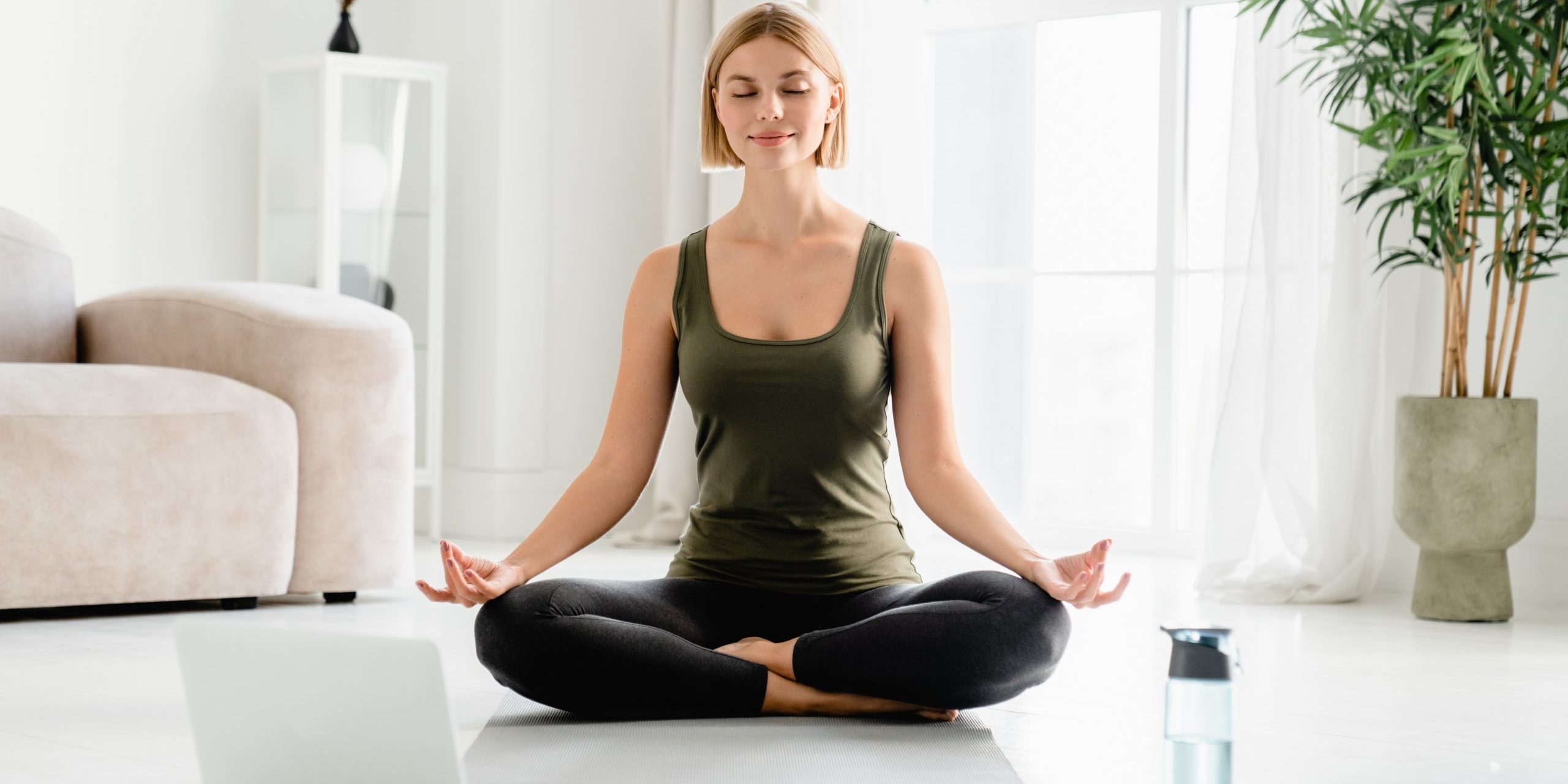 Young,Caucasian,Fit,Female,Sitting,In,Lotus,Position,During,Online