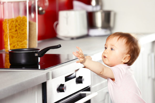 Little,Child,Playing,With,Pan,And,Electric,Stove,In,The